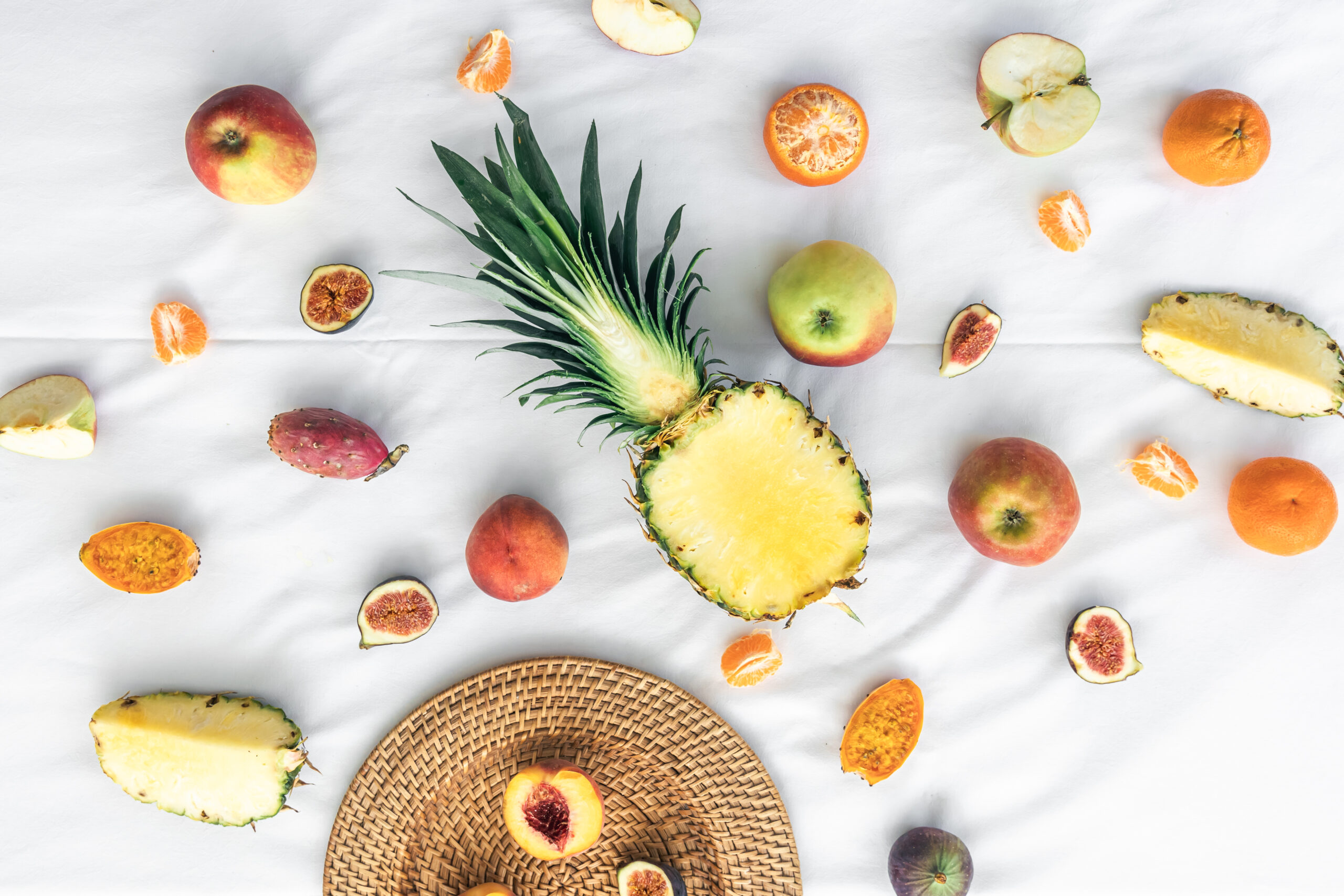 Fruit background with cut pineapple and other exotic fruits.